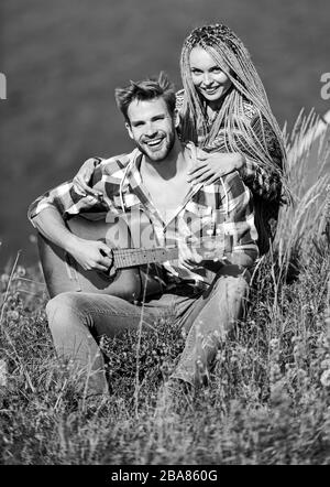 Aria fresca e sensazioni pure. Passeggiata romantica. Canzone romantica. L'amore li ispira. Bella coppia romantica felice sorridente volti natura sfondo. Ragazzo e ragazza con chitarra. Romanticismo escursionistico. Foto Stock