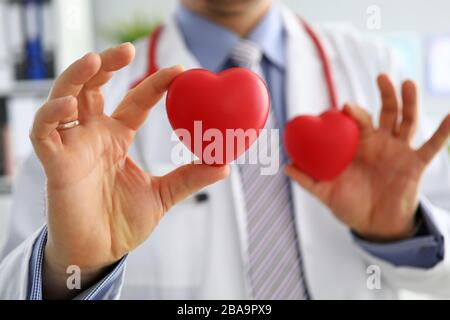 GP che mostra due cuori rossi in primo piano Foto Stock