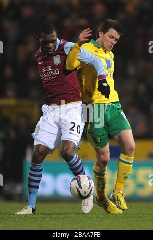 Christian Benteke di Aston Villa (a sinistra) e Jonny Howson di Norwich City (a destra) combattono per la palla Foto Stock