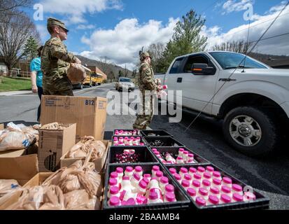 I soldati della Guardia Nazionale della Virginia Occidentale assistono i volontari con il Greater Greenbrier Long Term Recovery Committee nella preparazione dei pasti per più di 3,600 studenti in età scolare in tutta la contea di Greenbrier a sostegno del COVID-19, ordini di quarantena di coronavirus il 25 marzo 2020 a Lewisburg, Virginia Occidentale. Foto Stock