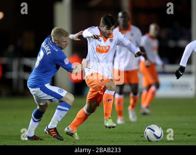 Craig Alcock di Peterborough United batte per il possesso della palla con Tiago Gomes di Blackpool Foto Stock