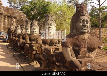 Porta sud vicino al tempio di Bayon di Angkor Thom / Angkor Wat in Cambogia con figure di pietra chiamati asuras o demoni divinità in possesso di un serpente chiamato shesha Foto Stock