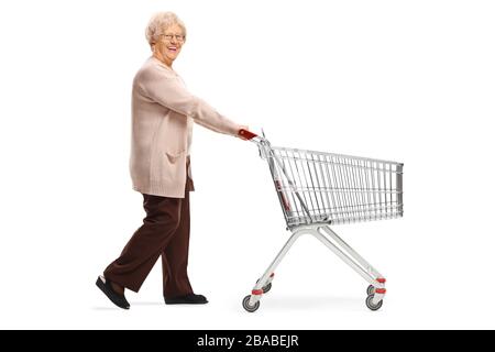 Scatto a lunghezza intera di una donna anziana che spinge un carrello vuoto isolato su sfondo bianco Foto Stock