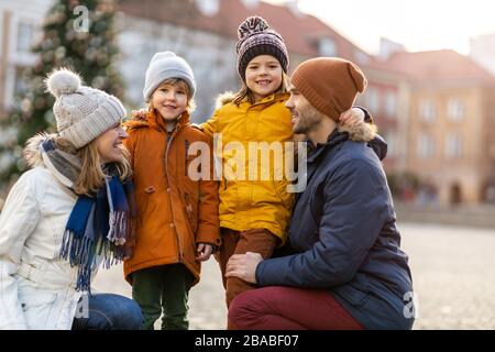 Affettuate la giovane famiglia godendovi la giornata in città Foto Stock