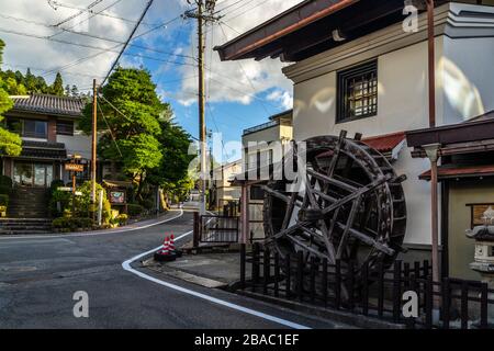 Un vecchio mulino ad acqua in un quartiere residenziale di Takayama, una piccola città affascinante nel cuore delle Alpi del Giappone, prefettura di Gifu Foto Stock