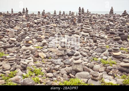 Stacks di pietra su una spiaggia, colore tonificante applicato. Foto Stock