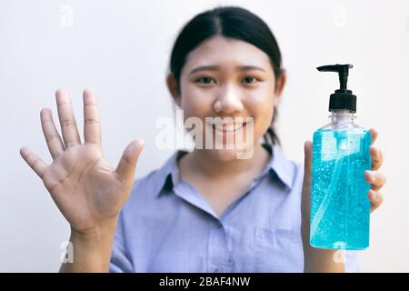 Pulire la mano utilizzando detergenti per la pulizia delle mani in gel di alcool per la protezione da becteria e da epidemie di coronavirus 2019 (COVID-19). Foto Stock