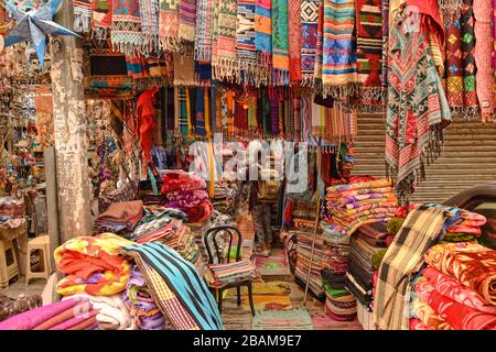 Acquistare sciarpe al vecchio mercato colorato a Nuova Delhi Foto Stock