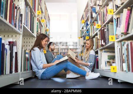Studenti universitari che lavorano nella biblioteca del campus Foto Stock