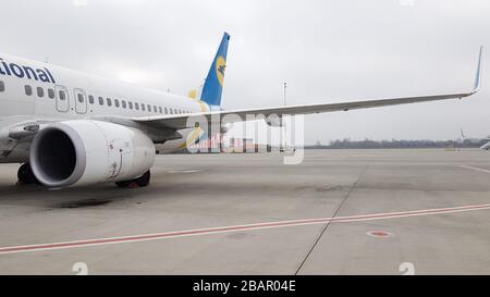 Ucraina, Borispol - 27 marzo 2020: Turbina a motore e ala di un grande aereo passeggeri in attesa di partenza all'aeroporto sullo sfondo del Foto Stock