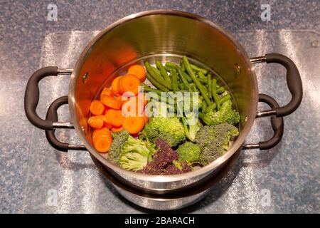 Preparazione di verdure fresche per la cena durante il blocco per il coronavirus, tenendo occupato mentre limitato in uscita a causa di Covid-19, Northampto Foto Stock