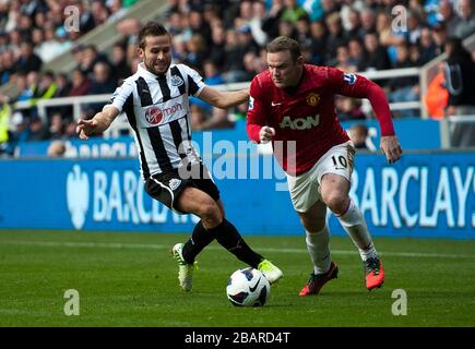Yohan Cabaye (a sinistra) del Newcastle United e Wayne Rooney del Manchester United combattono per la palla Foto Stock