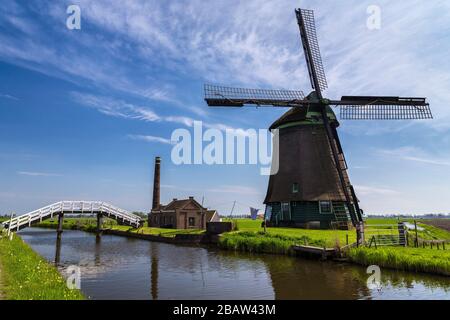 Il mulino a vento De Kaagmolen di fronte ad un canale e ad una barca (comune di OPmeer, Olanda del Nord, Paesi Bassi) Foto Stock