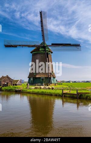 Il mulino a vento De Kaagmolen di fronte ad un canale e ad una barca (comune di OPmeer, Olanda del Nord, Paesi Bassi) Foto Stock