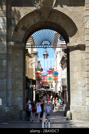 Appendendo ombrelloni multicolore appesi sopra le vie dello shopping di la Bastide Saint Louis, Carcassonne, Francia Foto Stock