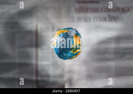 Il concetto di stampa mondiale. Focus è il layout del pianeta Terra sullo sfondo di un quotidiano sfocato defocused. Il mondo della stampa. WO Foto Stock