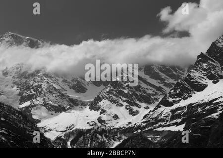 Vista in bianco e nero del monte rosa da Macugnaga, italia con nuvole Foto Stock