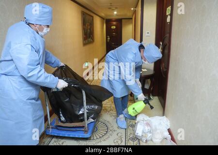 Shanghai, Cina. 30th Mar, 2020. I dipendenti puliscono i rifiuti in un punto di quarantena nel distretto di Songjiang di Shanghai, Cina, 30 marzo 2020. Un punto di quarantena che include 111 stanze per contenere la diffusione del nuovo coronavirus era stato impostato e messo in uso nel distretto di Songjiang di Shanghai che forniva supporto logistico, consultazione psicologica, traduzione linguistica e altri servizi. Credito: Ding Ting/Xinhua/Alamy Live News Foto Stock