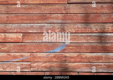 Struttura di una parete rivestita con listelli in legno con shabby e vernice rossa usurata. Immagine astratta per lo sfondo o per lo sfondo. Foto Stock