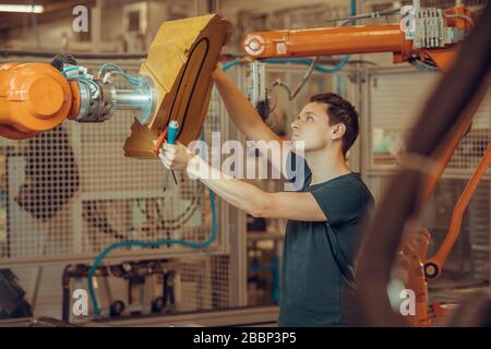 preparazione di un robot per la produzione di un nuovo tipo di auto nell'industria automobilistica Foto Stock