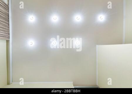 soffitto sospeso con lampade led e costruzione di cartongesso in camera vuota in appartamento o casa. Soffitto stretch bianco e forma complessa. Look Foto Stock