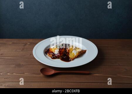 Omuraisu omu frittata di riso il cibo giapponese sulla piastra isolata sulla tabella Foto Stock