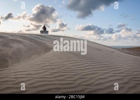 Danimarca, Lonstrup, duna di sabbia increspata con Rubjerg Knude Lighthouse sullo sfondo Foto Stock