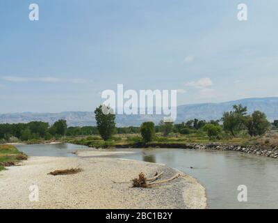 Ampio scatto del fiume Shoshone che scorre accanto alla North Fork Highway in Wyoming. Foto Stock