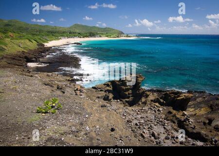 Le acque blu brillanti si avvicinano a questa costa rocciosa al largo di Oahu, Hawaii. Foto Stock