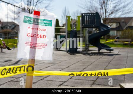 Un cartello chiuso per parco giochi a causa delle misure di prevenzione COVID-19 davanti ad un piccolo parco giochi. Foto Stock