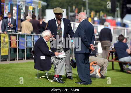 Racegoers immergiti nell'atmosfera dell'ippodromo di Epsom Foto Stock