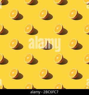 Modello senza giunture delle fette di arancia sul neo verde menta colore di sfondo. Minima, piatto, laici food texture. Foto Stock