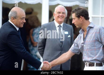 Mohamed al-Fayed (a sinistra) stringe le mani con HRH Prince Charles al polo club di Guards, Windsor, Inghilterra, giugno 1987 Foto Stock