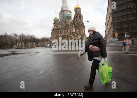 (200403) -- ST. PETERSBURG, 3 aprile 2020 (Xinhua) -- una maschera di protezione pedonale che indossa passeggiate a San Pietroburgo, Russia, 2 aprile 2020. La Russia ha conteggiato 4.149 casi di COVID-19 in 78 regioni a partire da venerdì, con un aumento di 601 del giorno precedente, dati ufficiali riportati. (Foto di Irina Motina/Xinhua) Foto Stock