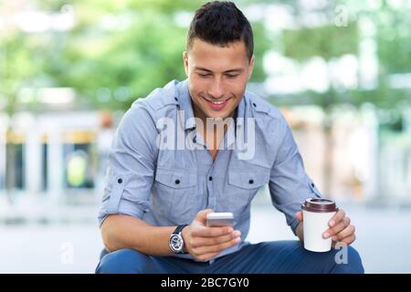 Giovane uomo con il suo smartphone Foto Stock