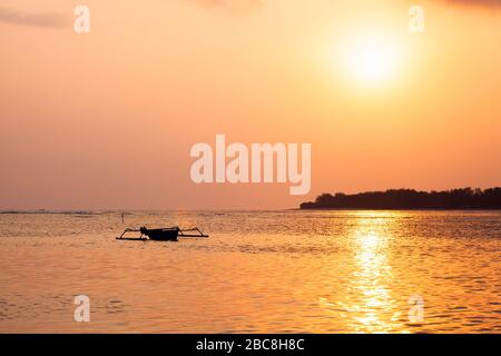 Asia, Indonesia, West Nusa Tenggara, Gili Air, Tramonto su Gili Meno con Barca tradizionale Outrigger Foto Stock