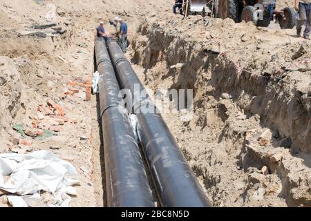 Posa di tubi di grande diametro per sostituire la rete di riscaldamento Foto Stock