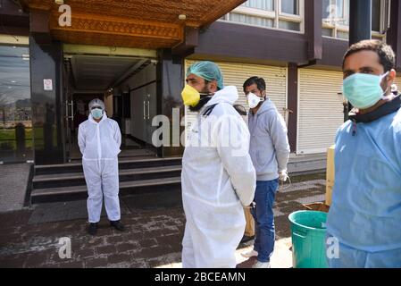 Il personale medico che indossa gli attrezzi protettivi guarda su come gli studenti che studiano all'estero vanno dopo aver completato 14 giorni di quarantena in un hotel convertito centro di quarantena a Srinagar.il primo ministro indiano Narendra modi ha detto questa settimana il paese tirerà fuori dal blocco previsto di tre settimane in un modo graduale. L'India è stata colpita più duramente dalla malattia nell'Asia meridionale, con circa 2.902 casi, di cui 68 sono morti. A livello globale, il virus continua a causare il caos, poiché la cifra delle persone infette è salita a 1.118.059. Il maggior numero di casi è stato segnalato dagli Stati Uniti a 277.161 (7.392 morti) come globa Foto Stock