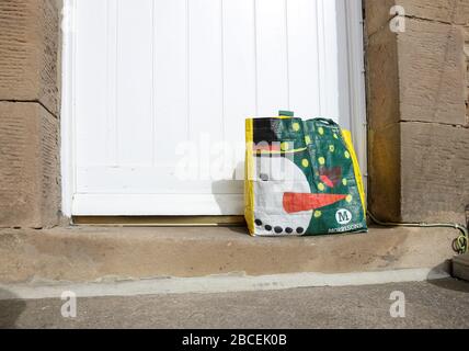 Shopping lasciato dalla porta di una casa per le persone che sono in isolamento a causa del Coronavirus (Covid-19), Inghilterra, Regno Unito Foto Stock