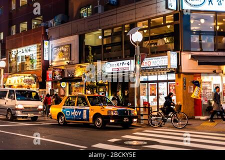 Shinjuku, Giappone - 3 aprile 2019: Kitashishinishee Otakibashi-dori strada intersezione a Hyakunincho con persone, auto e taxi giallo ca Foto Stock