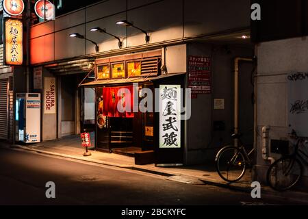 Shinjuku, Giappone - 3 aprile 2019: Segnale per sakura House e Menya Musashi Sohonten ramen negozio di ristoranti all'aperto di notte a Tokyo c Foto Stock