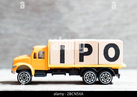 Blocco di lettere di tenuta del camion in parola IPO (abbreviazione di offerta pubblica iniziale) su sfondo di legno Foto Stock