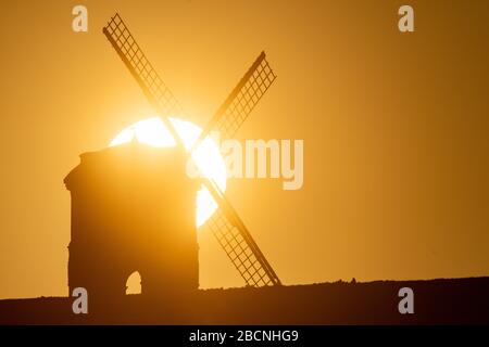 Il sole sorge su Chesterton Windmill nel Warwickshire. Foto Stock