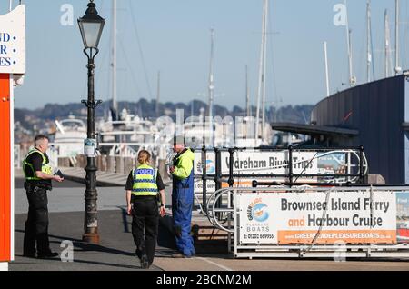 Poole, Dorset, Regno Unito. 4th aprile 2020. Un poole Quay quasi deserta a Dorset nel weekend più caldo dell'anno finora. La destinazione popolare sarebbe normalmente imballato con i visitatori che approfittano delle molte barche di piacere che offrono viaggi intorno al porto di Poole e all'isola di Brownsea. Le barche invece si trovano a riposo sul lato del quad con la maggior parte delle persone che si sono eravate le avvertenze di rimanere lontano da hotspot turistici durante il periodo di blocco COVID-19, Coronavirus pandemic. Credito: Richard crease/Alamy Live News Foto Stock