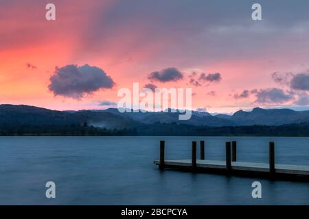 Lago Windermere guardando verso i Langdale Pikes al tramonto Foto Stock