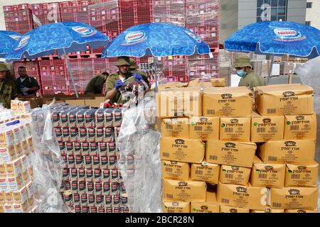 Modiin. 5th Apr, 2020. I soldati israeliani raccolgono e distribuiscono pacchetti alimentari a 350.000 anziani israeliani in un centro logistico nella città centrale israeliana di Modiin, in mezzo alla pandemia di coronavirus, il 5 aprile 2020. Credit: Gil Cohen Magen/Xinhua/Alamy Live News Foto Stock