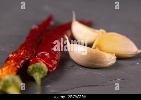 Peperoncini rossi caldi e aglio, isolati su nero Foto Stock