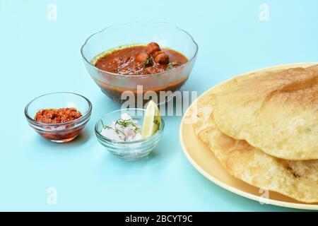 Piatto indiano piccante Chick Peas curry noto anche come Chole Bhatura e Chana Masala, tradizionale pranzo indiano del nord servito con puri fritti o pane piatto Foto Stock