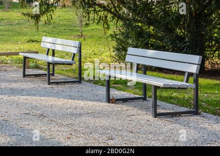 Due panchine in un parco con tempo soleggiato primo piano Foto Stock