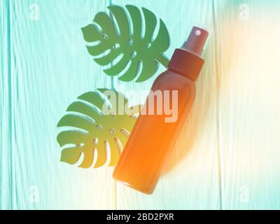 black bottle with sunscreen, antiseptic, sunscreen, empty bottle against a brick wall Foto Stock
